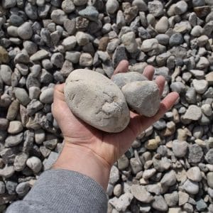 Holding 1-3 River Rock